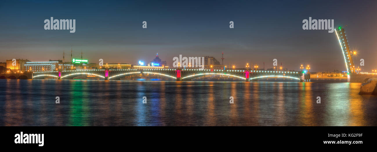 Night panoramic view of illumunated open Trinity Bridge and Neva River, St. Petersburg, Russia Stock Photo