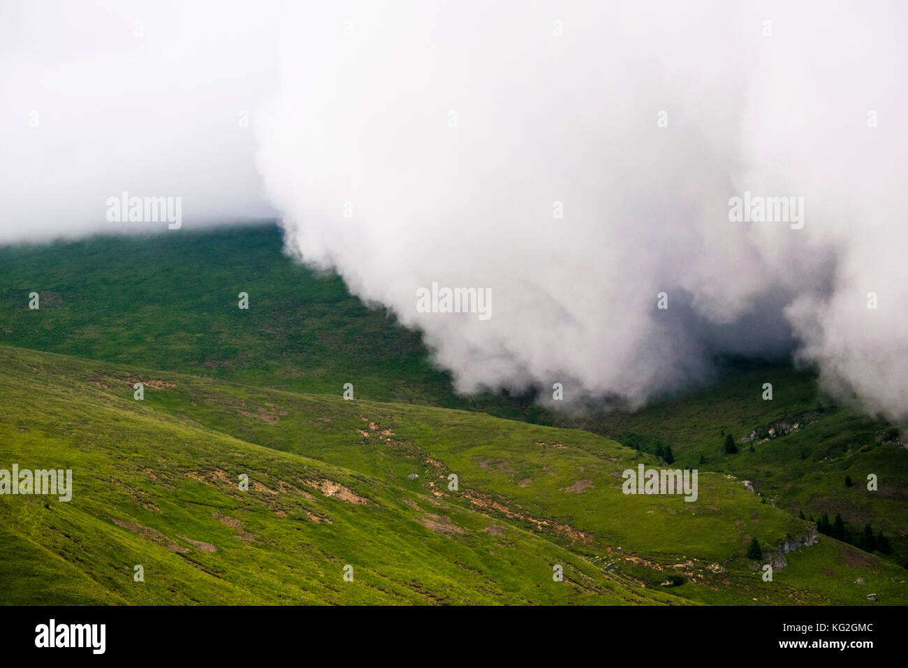 Clouds rolling over a mountain before the storm Stock Photo - Alamy