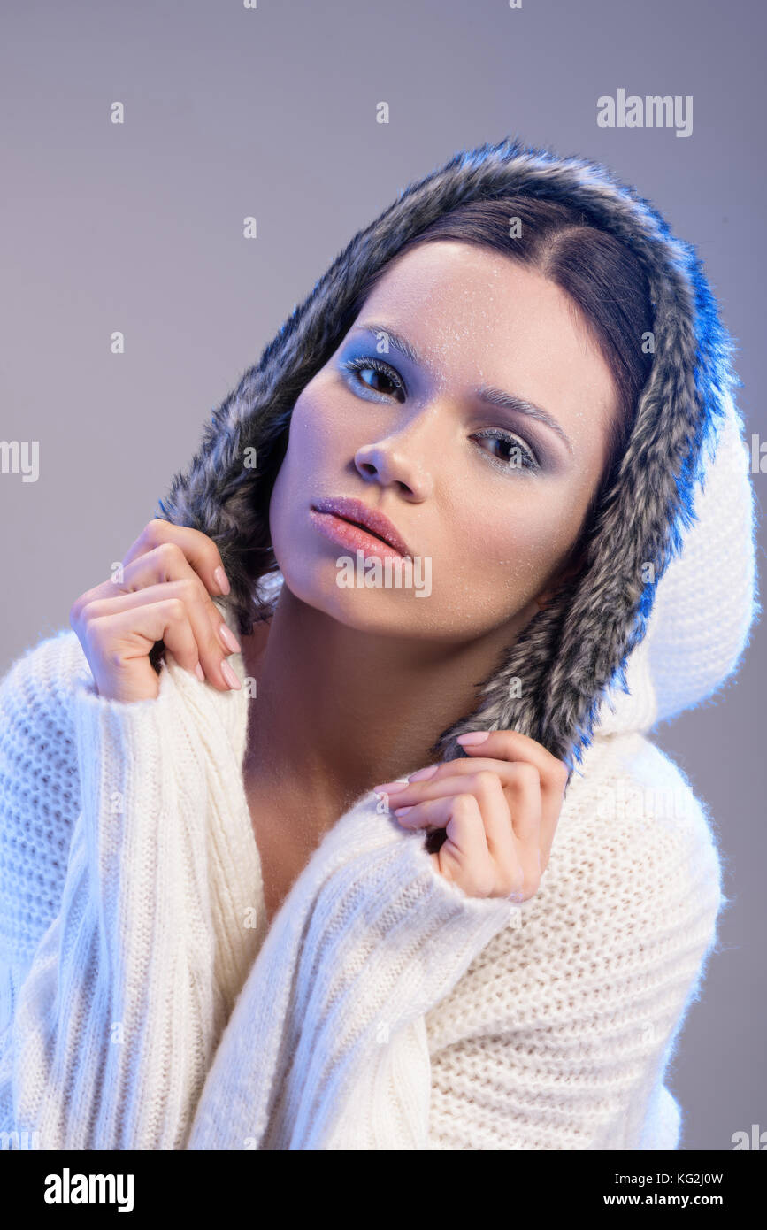 woman in hooded sweater Stock Photo
