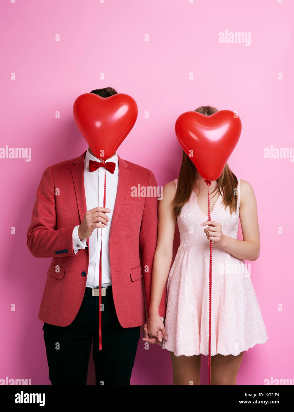 Unrecognizable couple with balloon holding hands Stock Photo