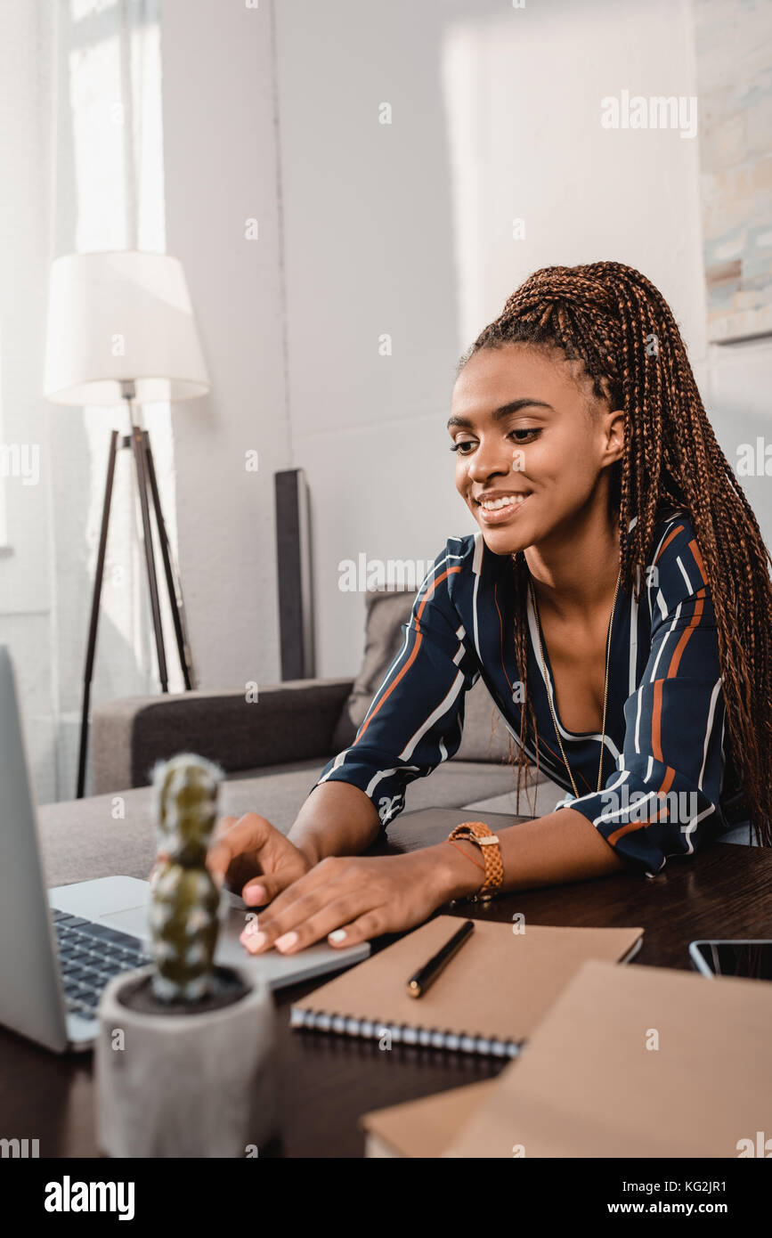 woman using laptop on couch Stock Photo - Alamy