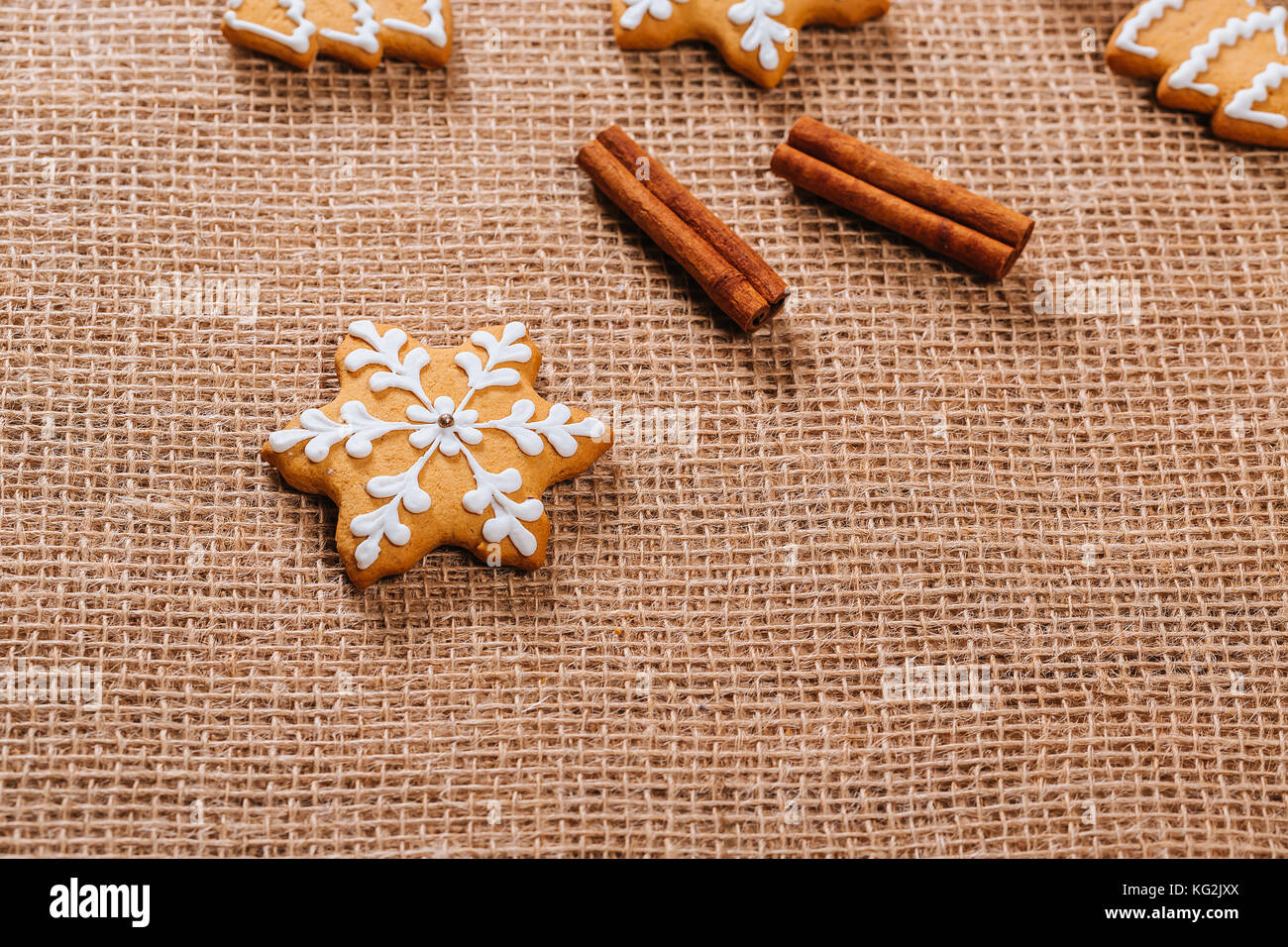Christmas gingerbread cookies homemade and New Year decor on table with burlap tablecloth. Merry Christmas postcard. Stock Photo