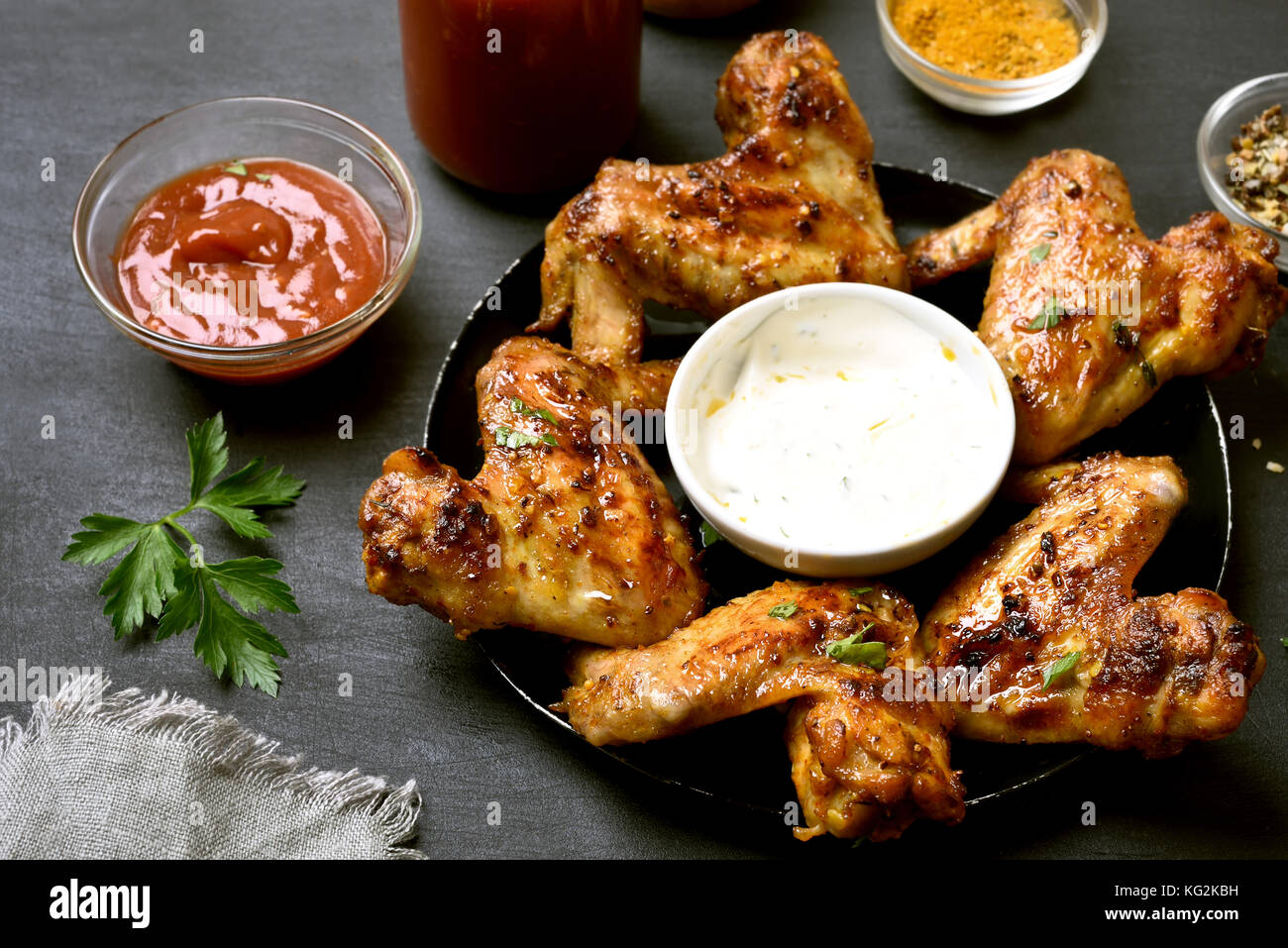 Fried chicken wings with sauce on dark background Stock Photo - Alamy