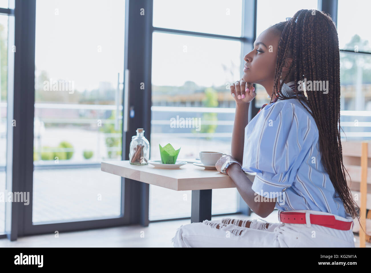 African woman sitting alone side view hi-res stock photography and ...