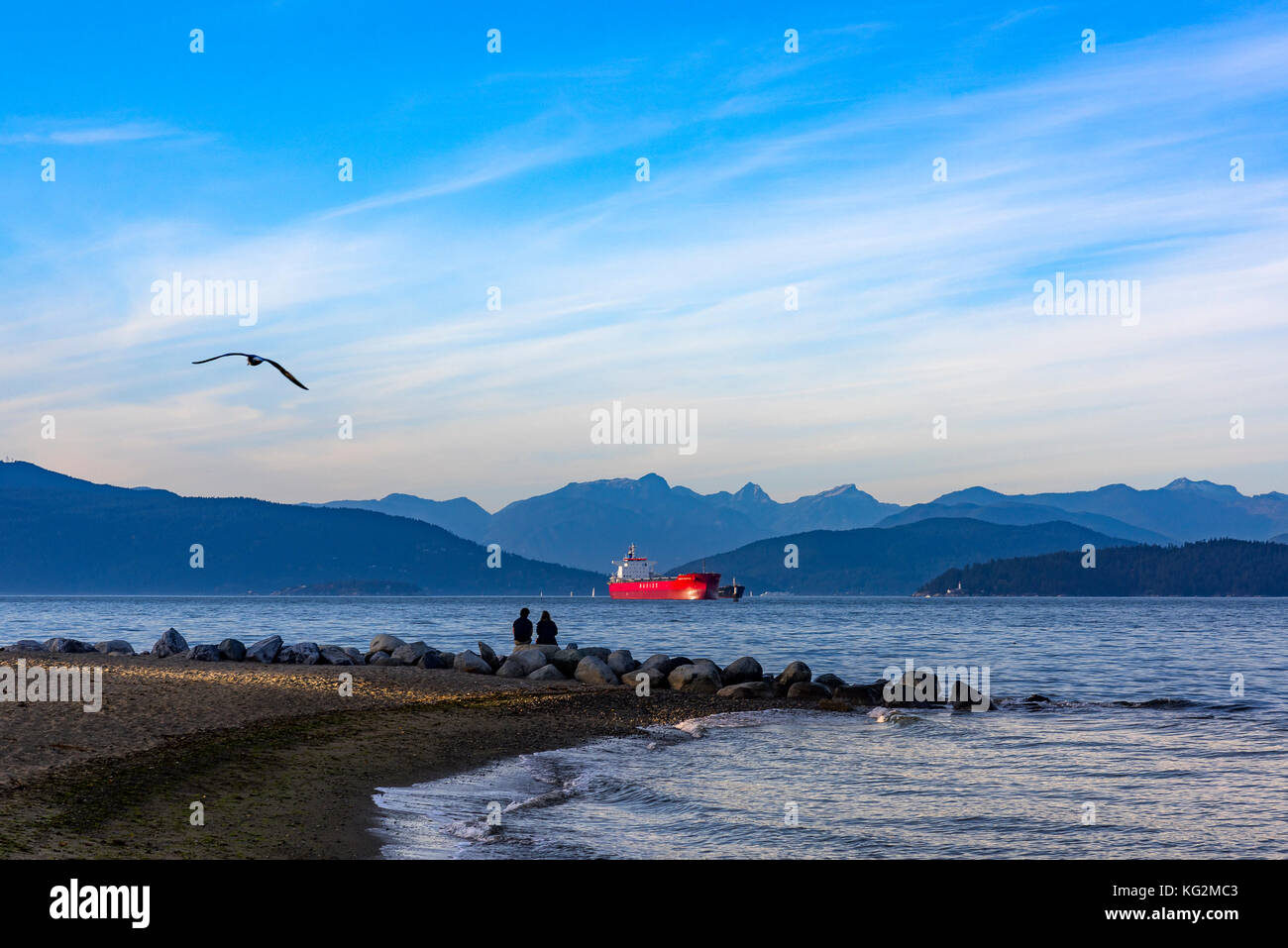 Couple enjoying the view at Spanish Banks, English Bay. Vancouver