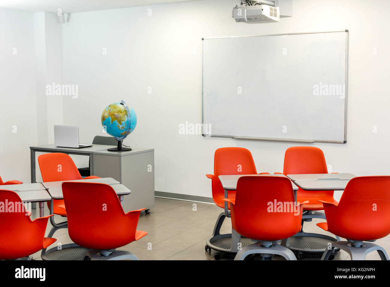 Modern classroom interior, with white board and movable tables and chairs. Stock Photo