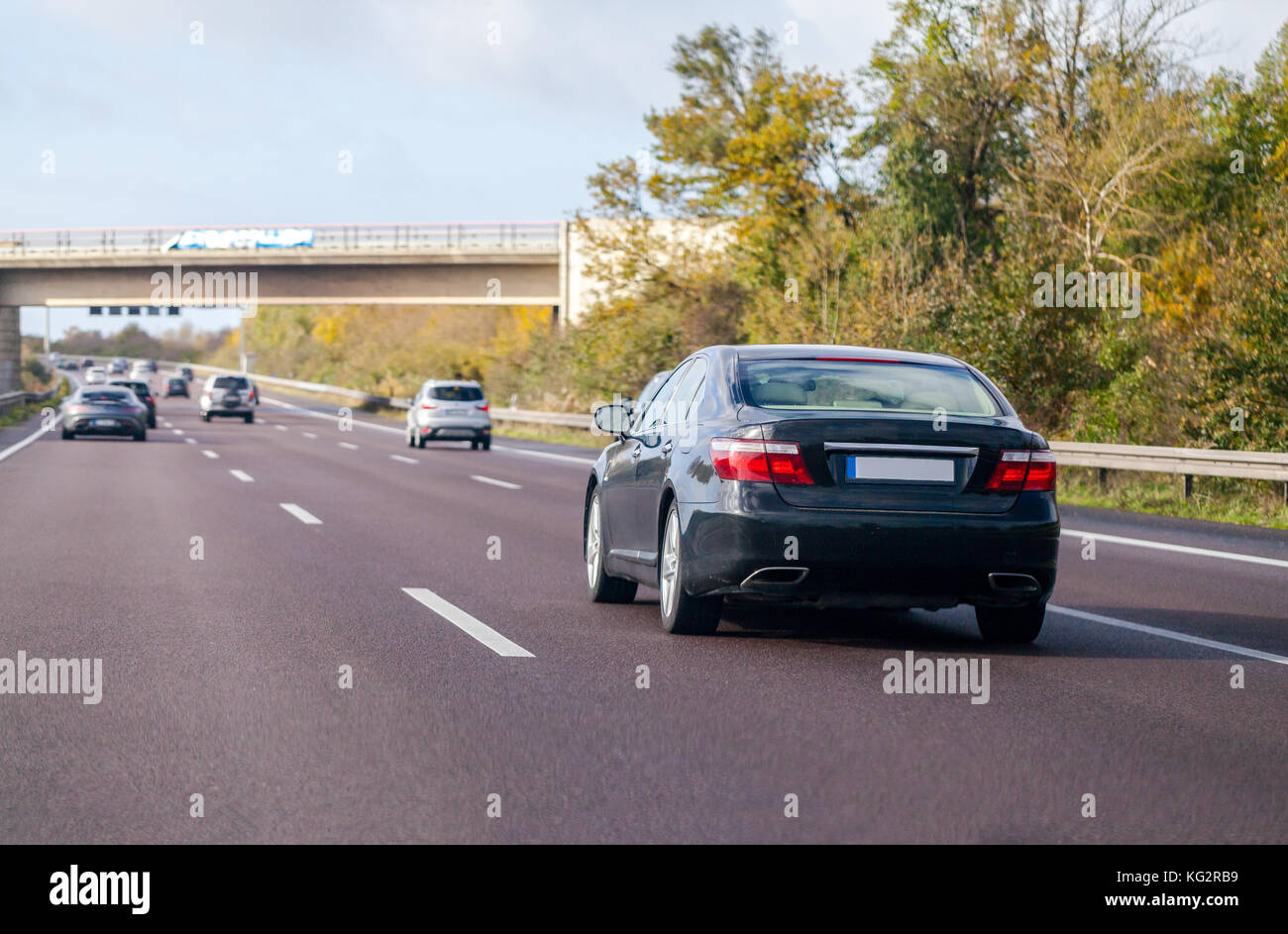 blue car drives on a german motorway Stock Photo