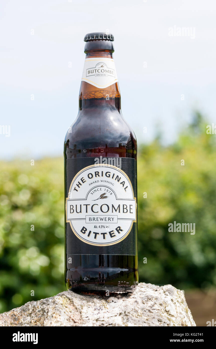 A bottle of Butcombe Bitter in the Somerset countryside.  It has a strength of 4.5% ABV. Stock Photo