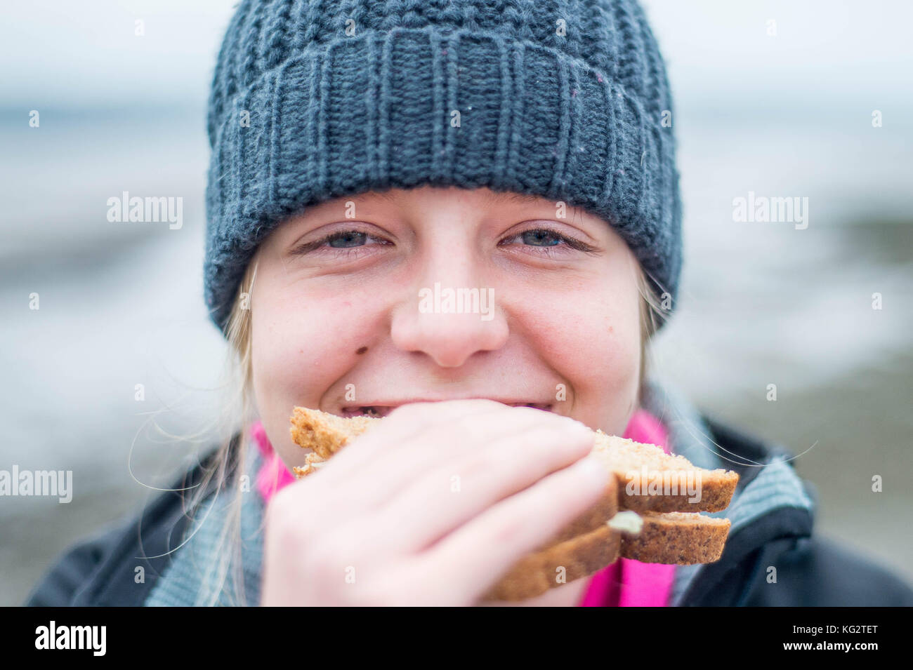 Thursday  02 November 2017 A 11,12,13, year old girl eats a healthy sandwich outside Stock Photo