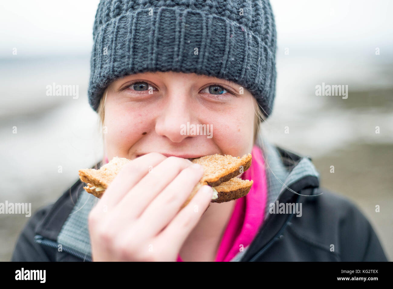 Thursday  02 November 2017 A 11,12,13, year old girl eats a healthy sandwich outside Stock Photo