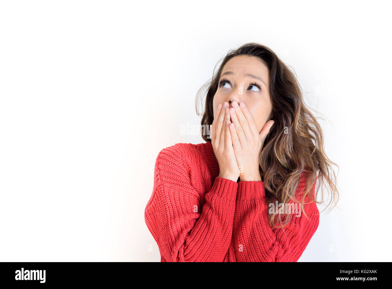 Asian teen woman red dress scared expression with hands over face looking up isolated on white background Stock Photo