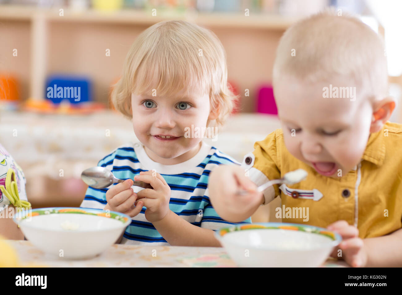 Kids eating in kindergarten Stock Photo