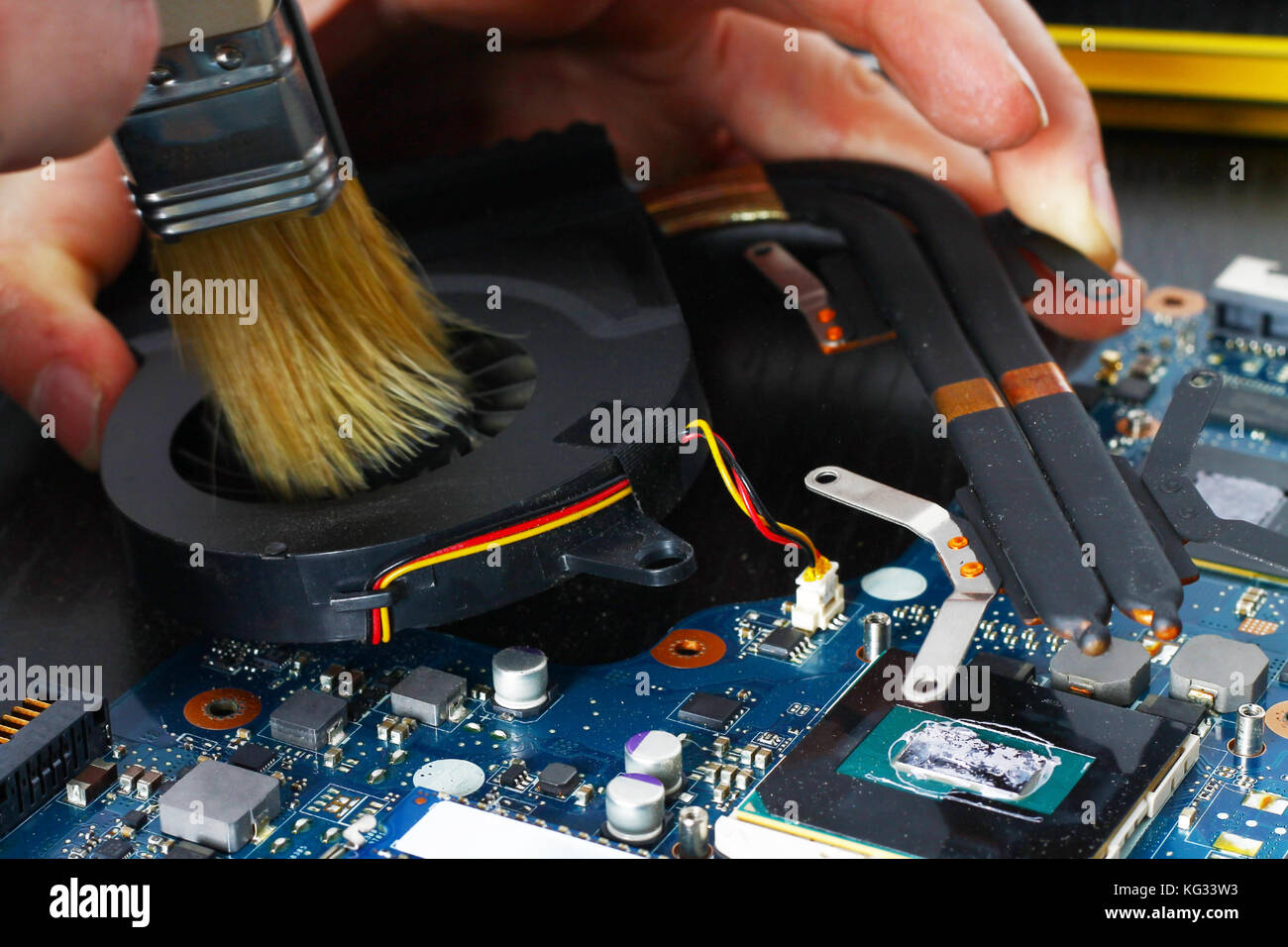 Notebook cooling system cleaning with a brush during service