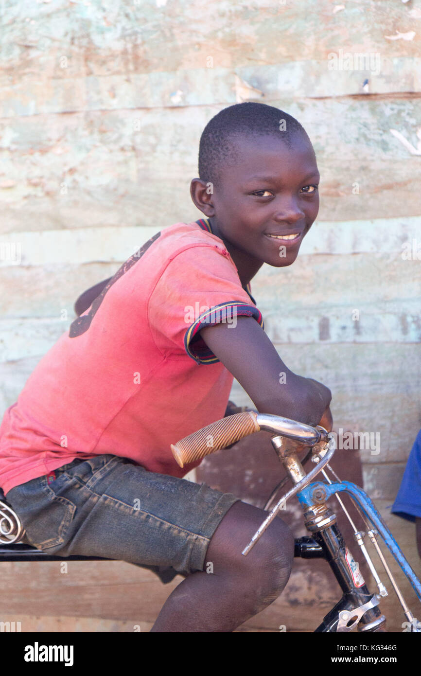 Young boy sitting on a bike. Stock Photo