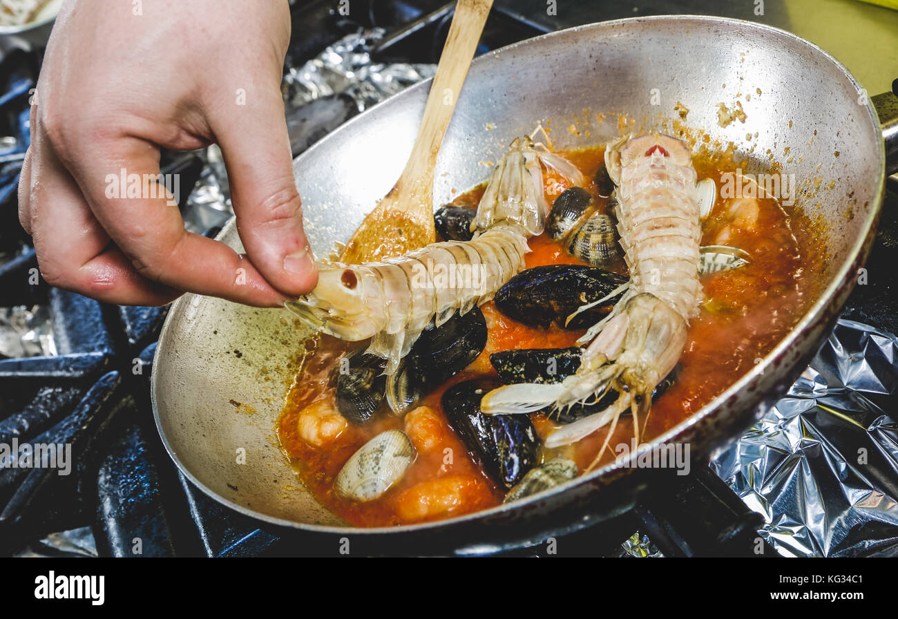 Preparing shellfish dressing for pasta Stock Photo