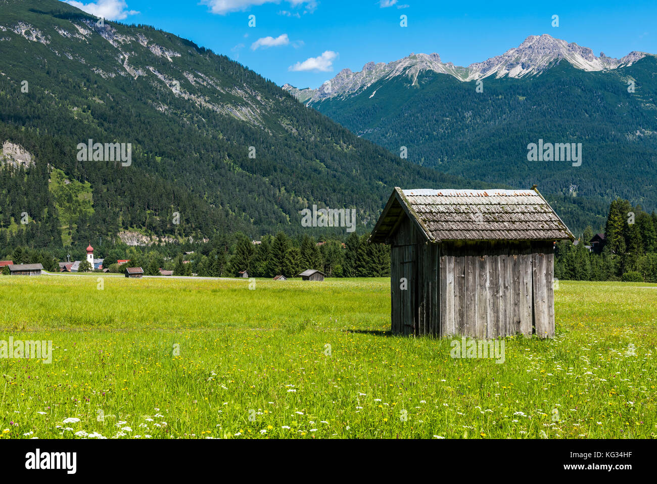 Cabin in the valley of the Lech near Stanzach, Austria with in the background the Austrian mountains on a summers day. Stock Photo