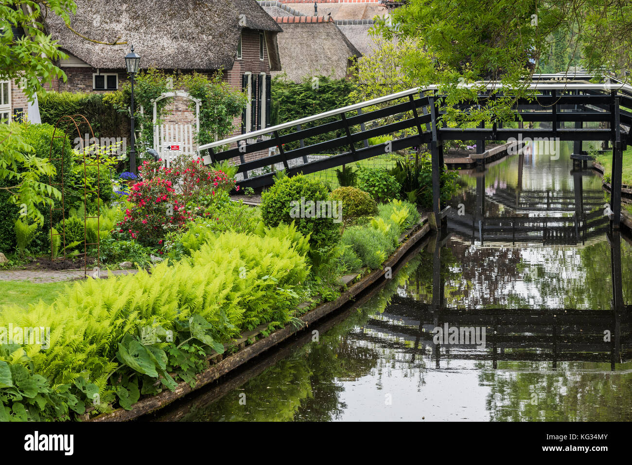 Giethoorn, The Netherlands - May 19., 2016:  Canal, bridges and monumental houses in the small, picturesque town of Giethoorn, Overijssel, Netherlands Stock Photo