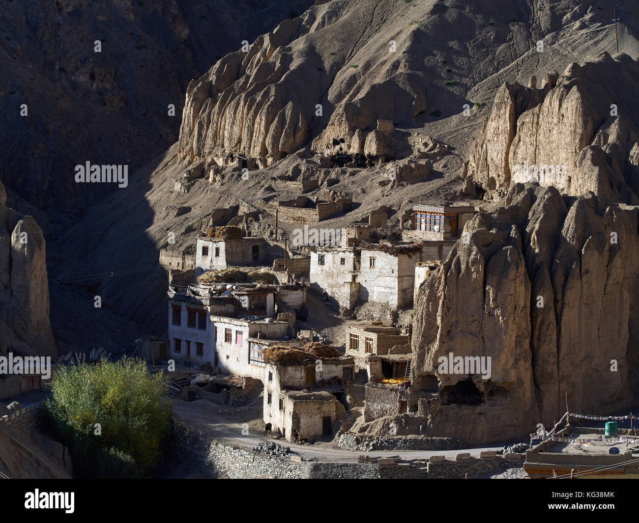 Mountain village of Lamayuru, white houses stand among high vertical rocks, are lit by the rays of the setting sun, Ladakh, the Himalayas, Northern In Stock Photo