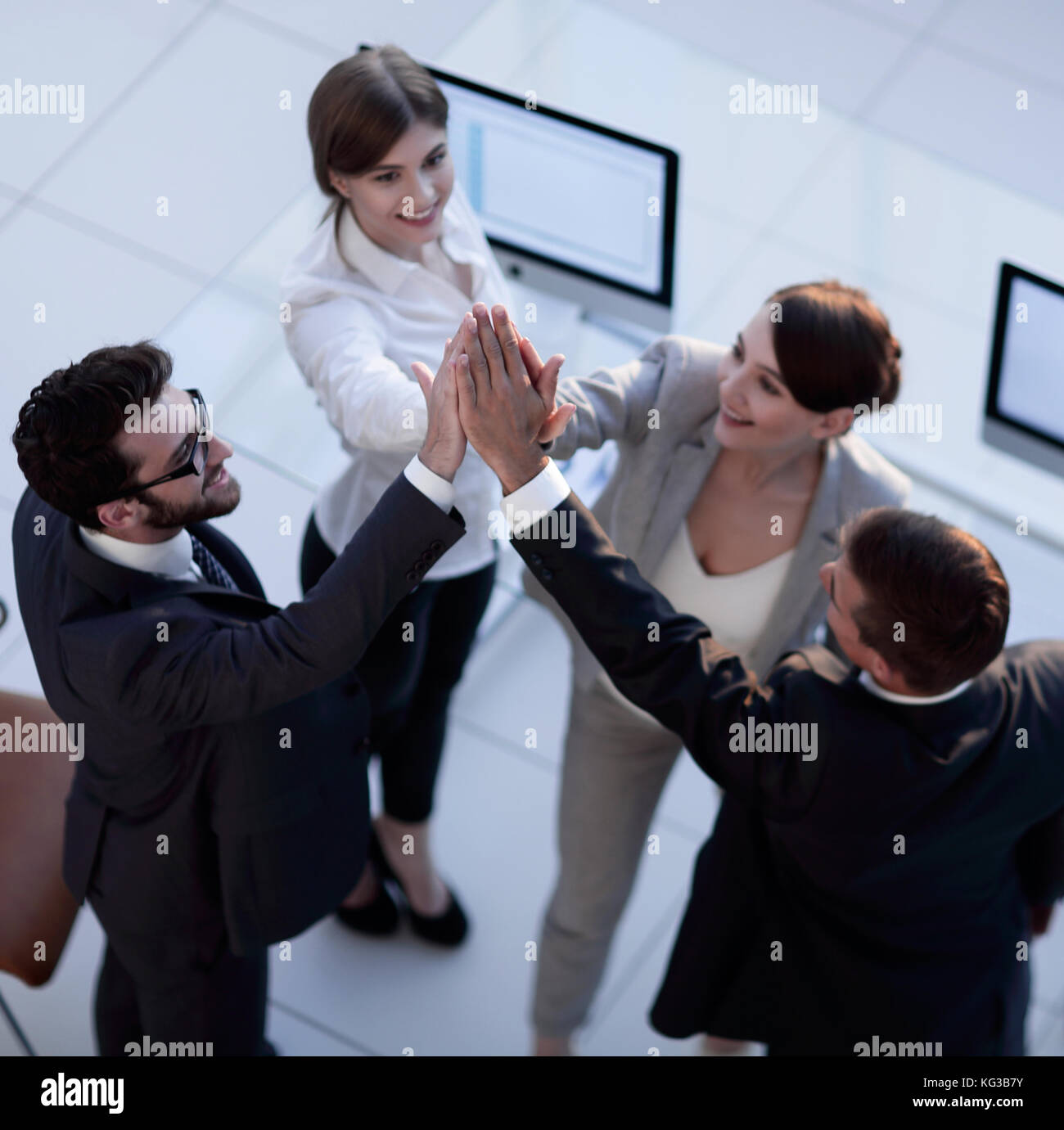 successful business team giving each other a high-five, standing in the ...