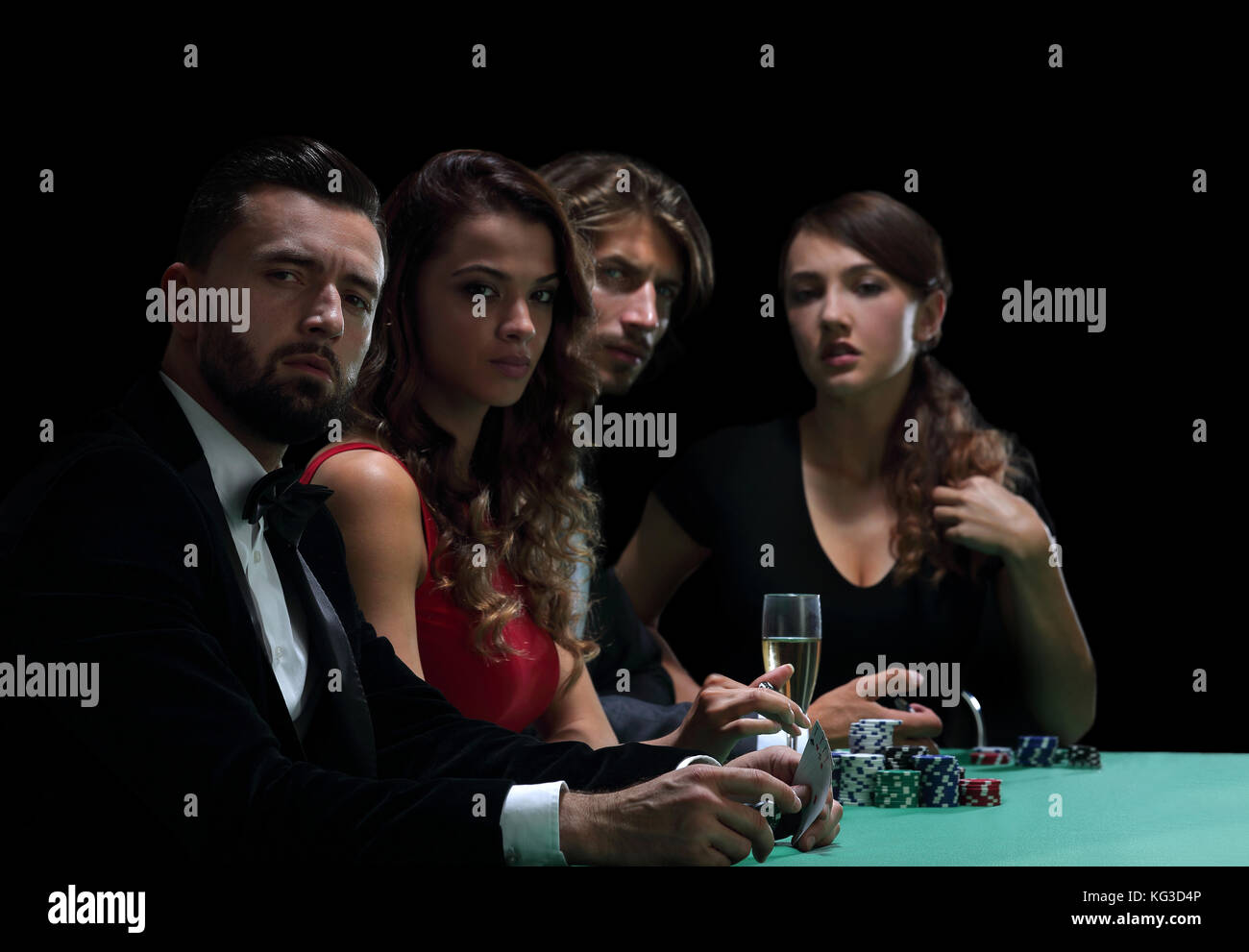 side view of group of people playing poker together in casino Stock Photo