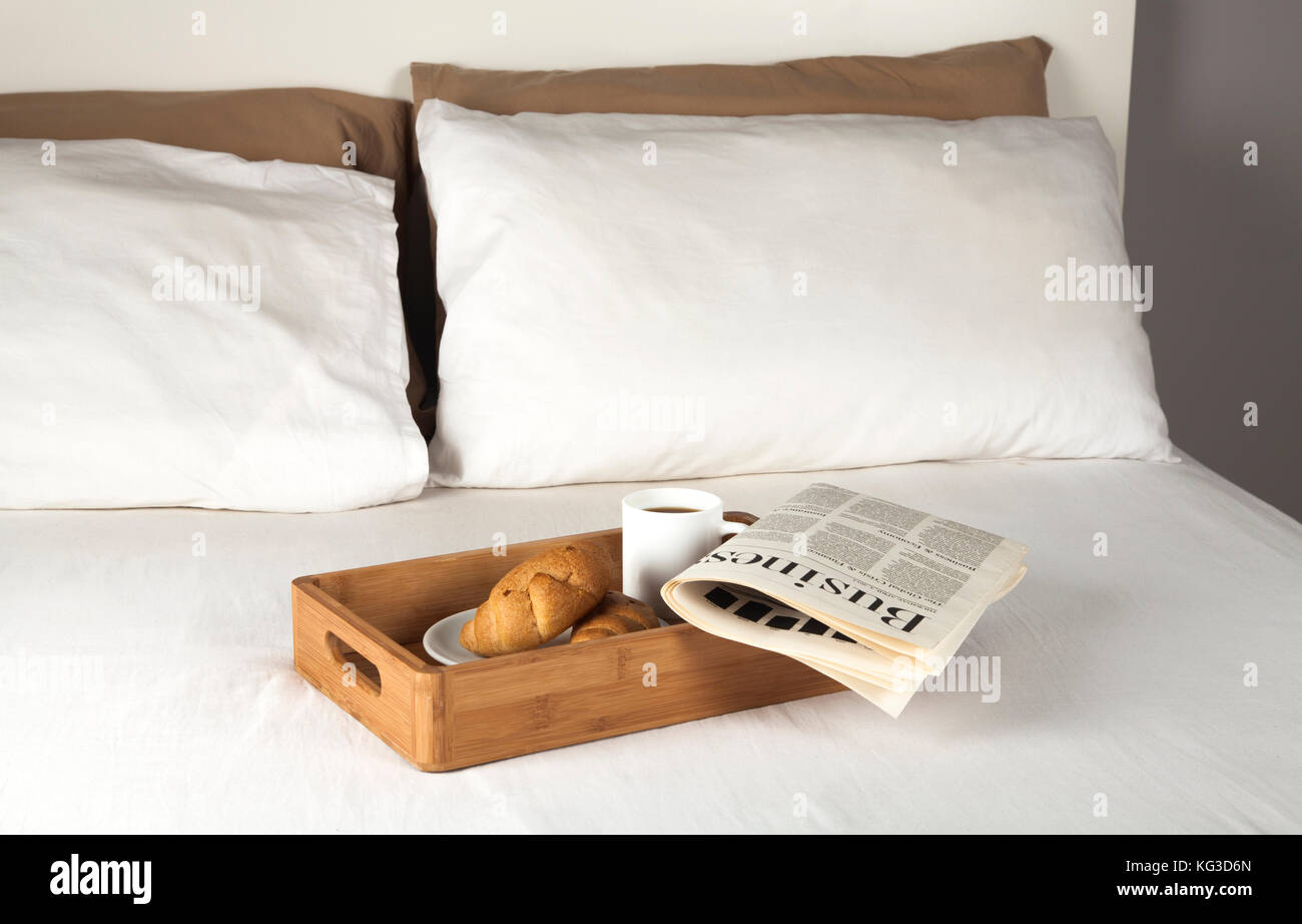 Breakfast tray and newspaper on a bed Stock Photo Alamy