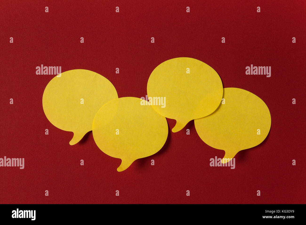 Yellow stickers with shape of speech bubble on red background Stock ...