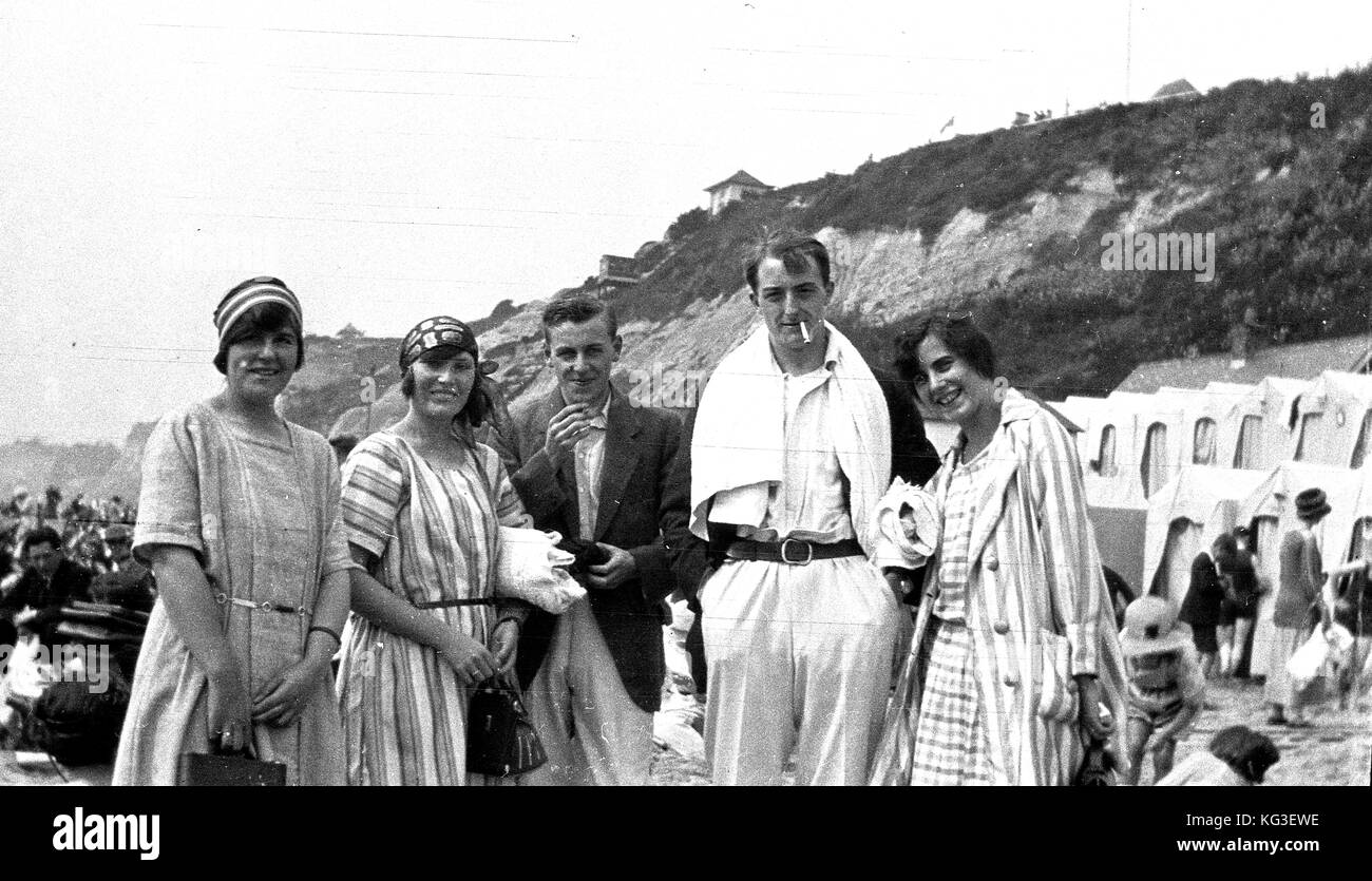 Young couples pose at the seaside with towels ready for bathing. The UK c1932  Photograph by Tony Henshaw Stock Photo