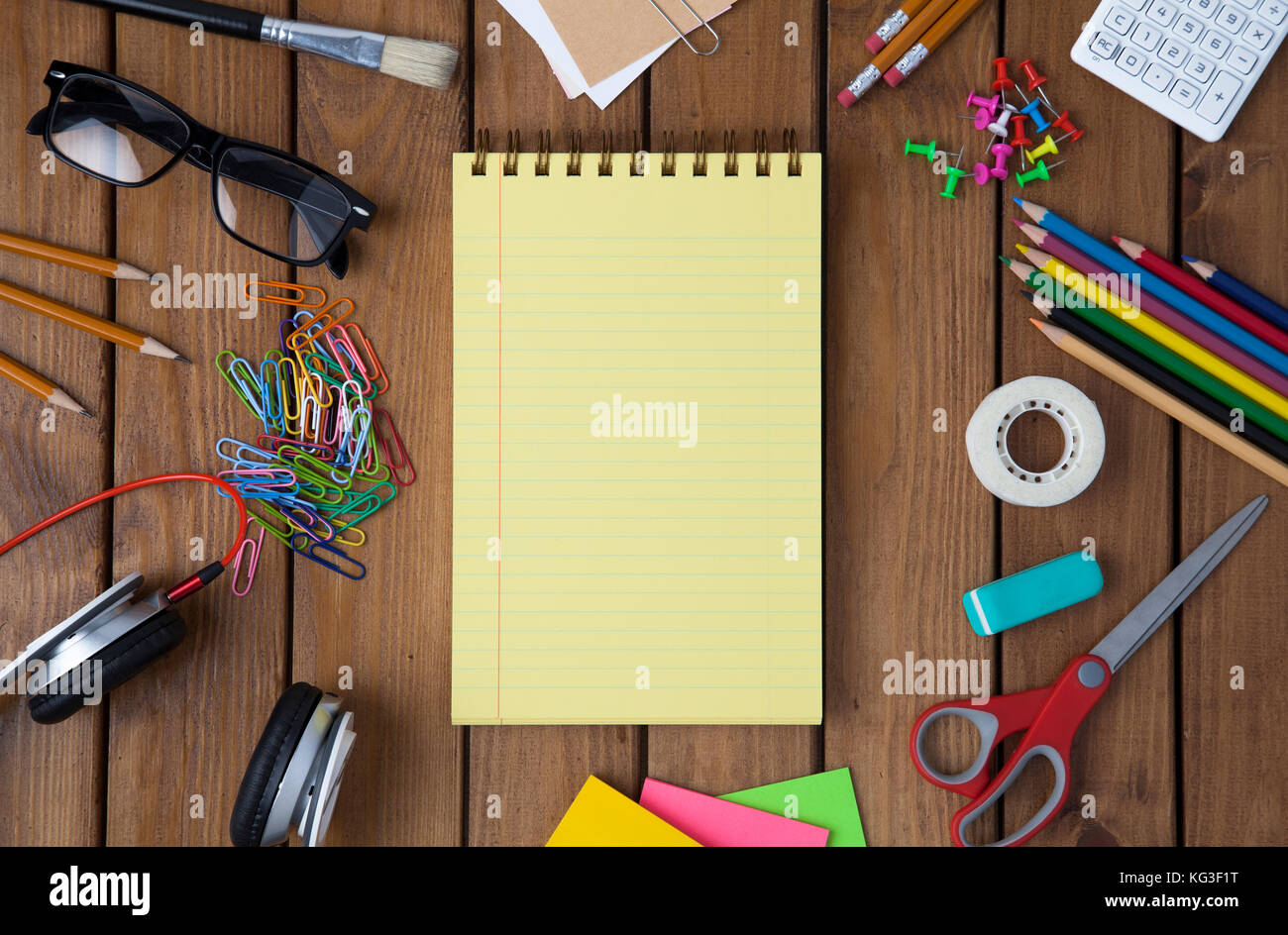 Miscellaneous office material on wooden background, directly above shot Stock Photo