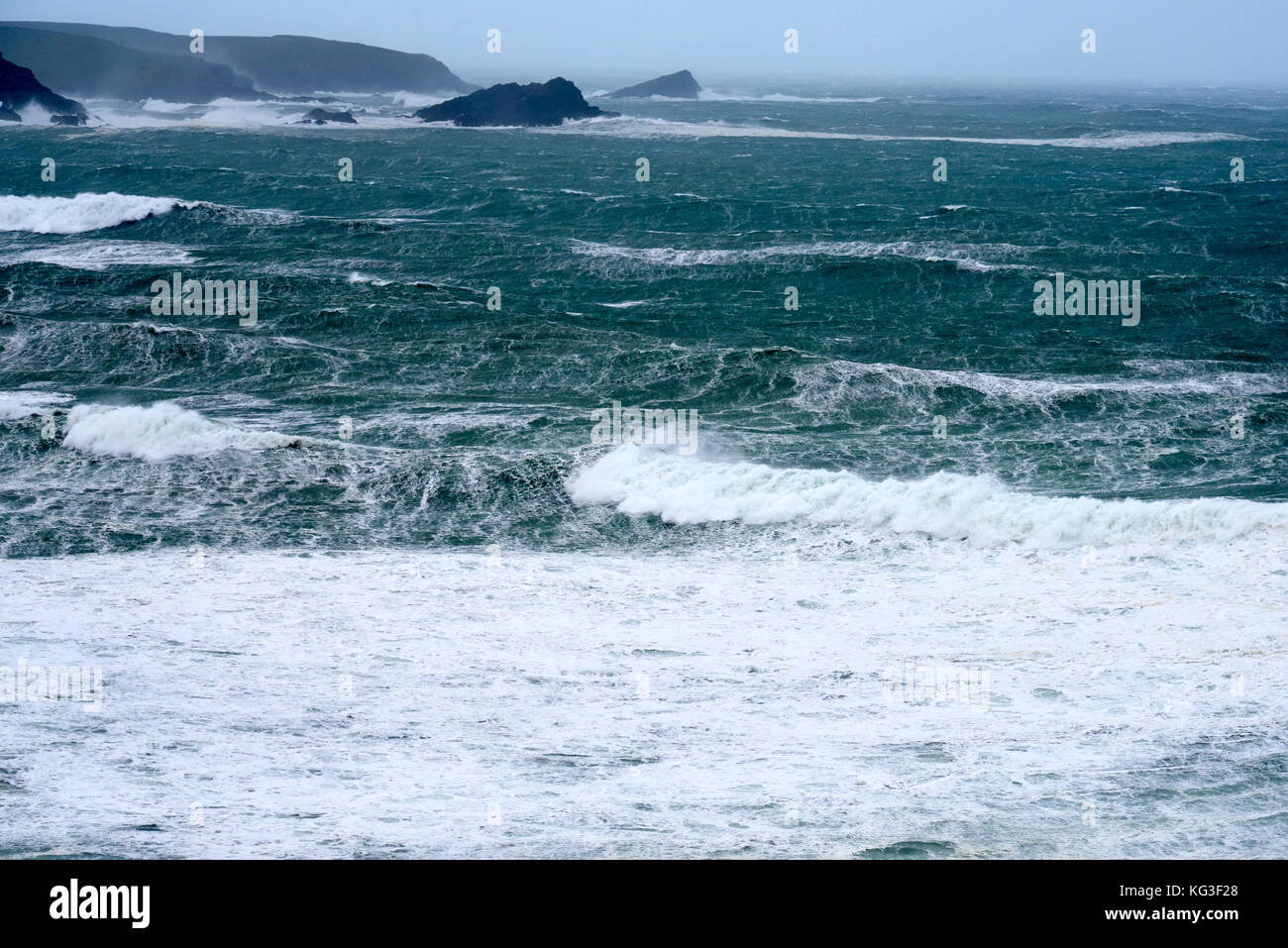 Waves roll in from the rough Atlantic Ocean towards the Cornish coast Stock Photo