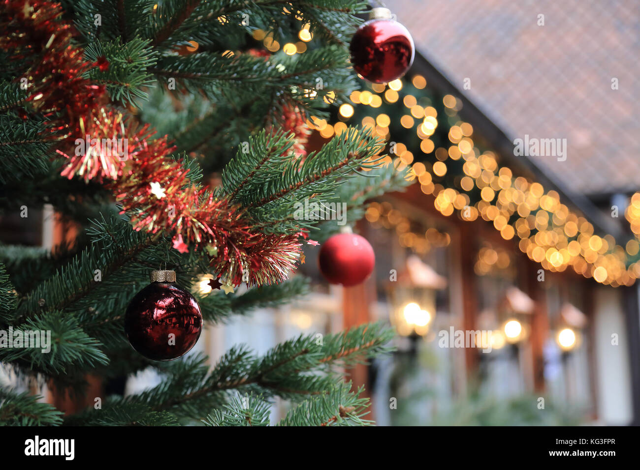 Christmas street decorations - red ball, fir and bokeh lights Stock ...