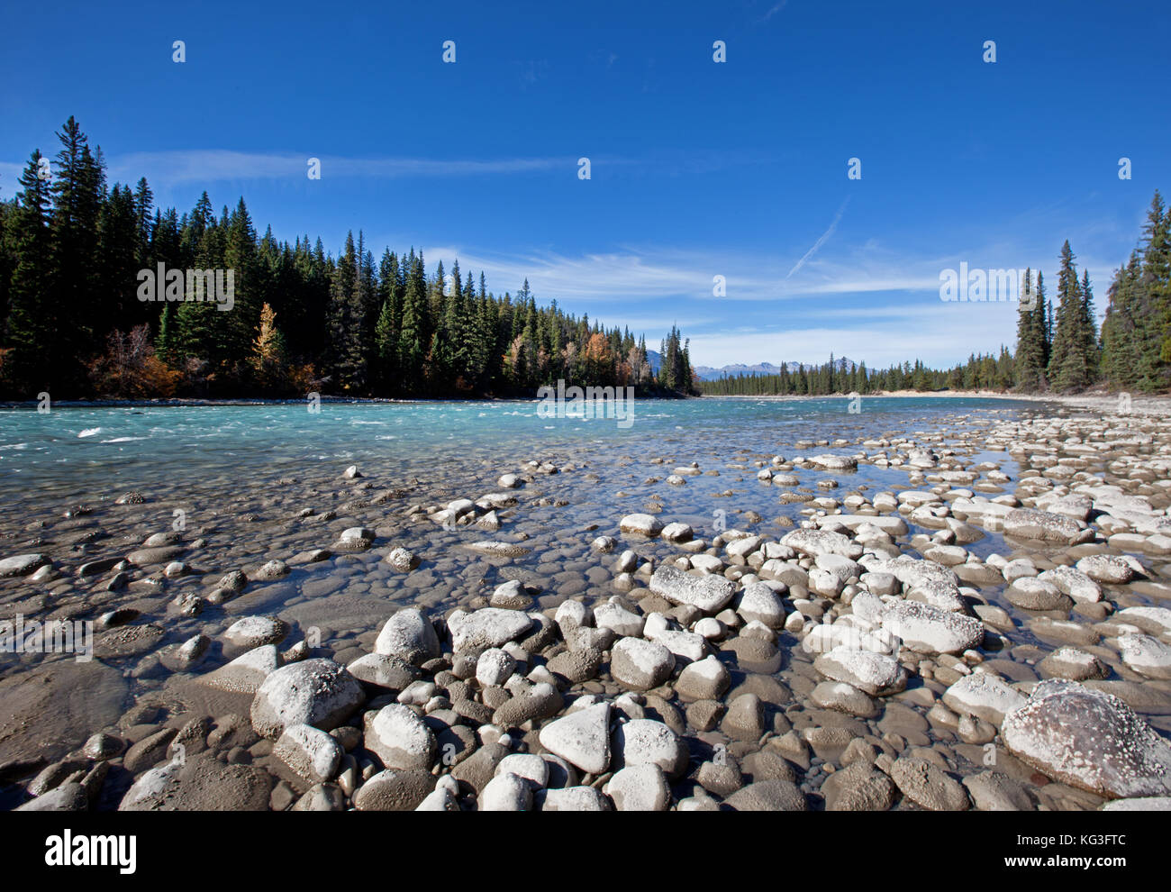A beautiful stream with rocks and a hint of autumn in the forest Stock Photo