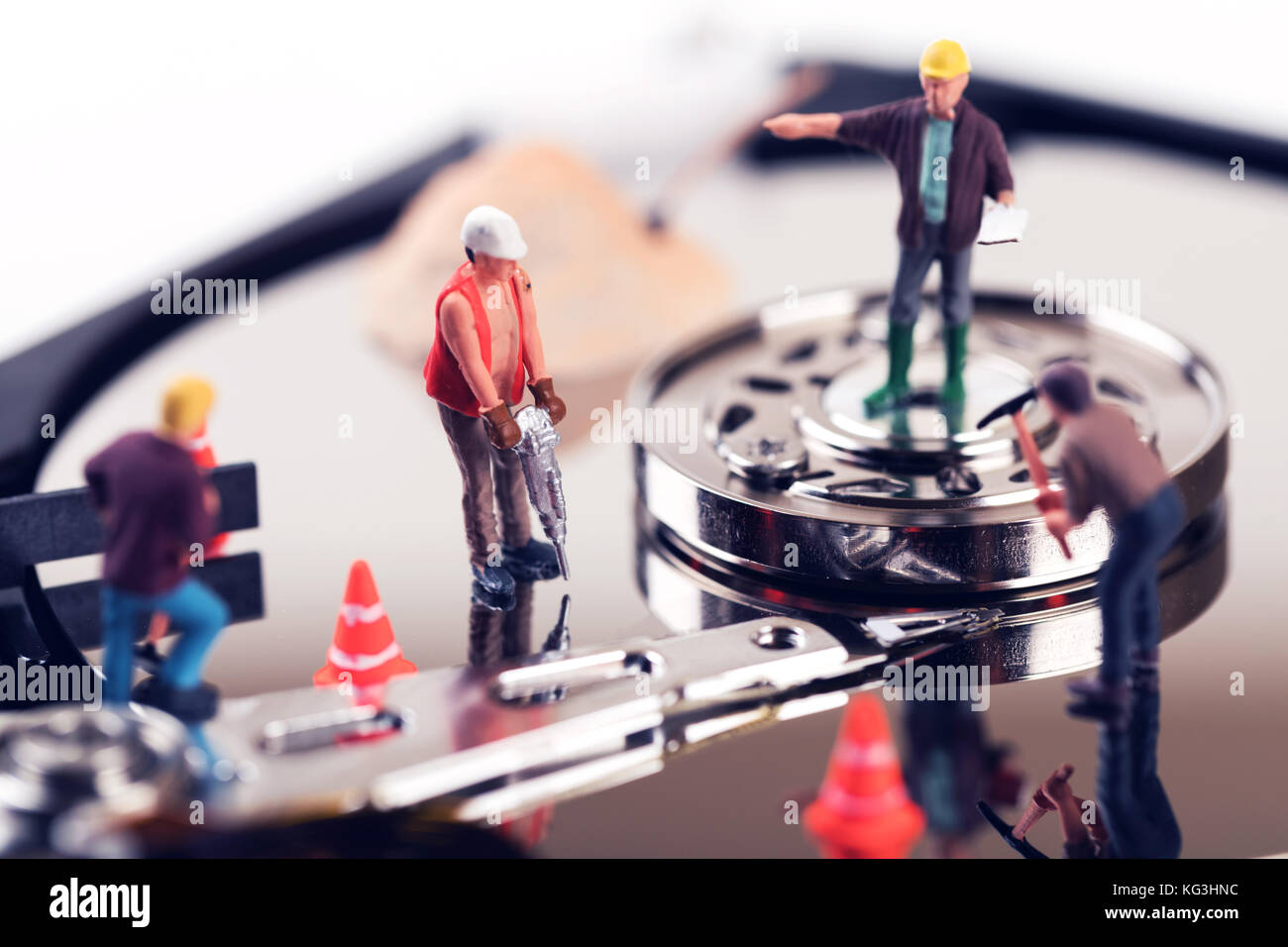 data recovery concept. construction worker figurines on hard disk drive Stock Photo