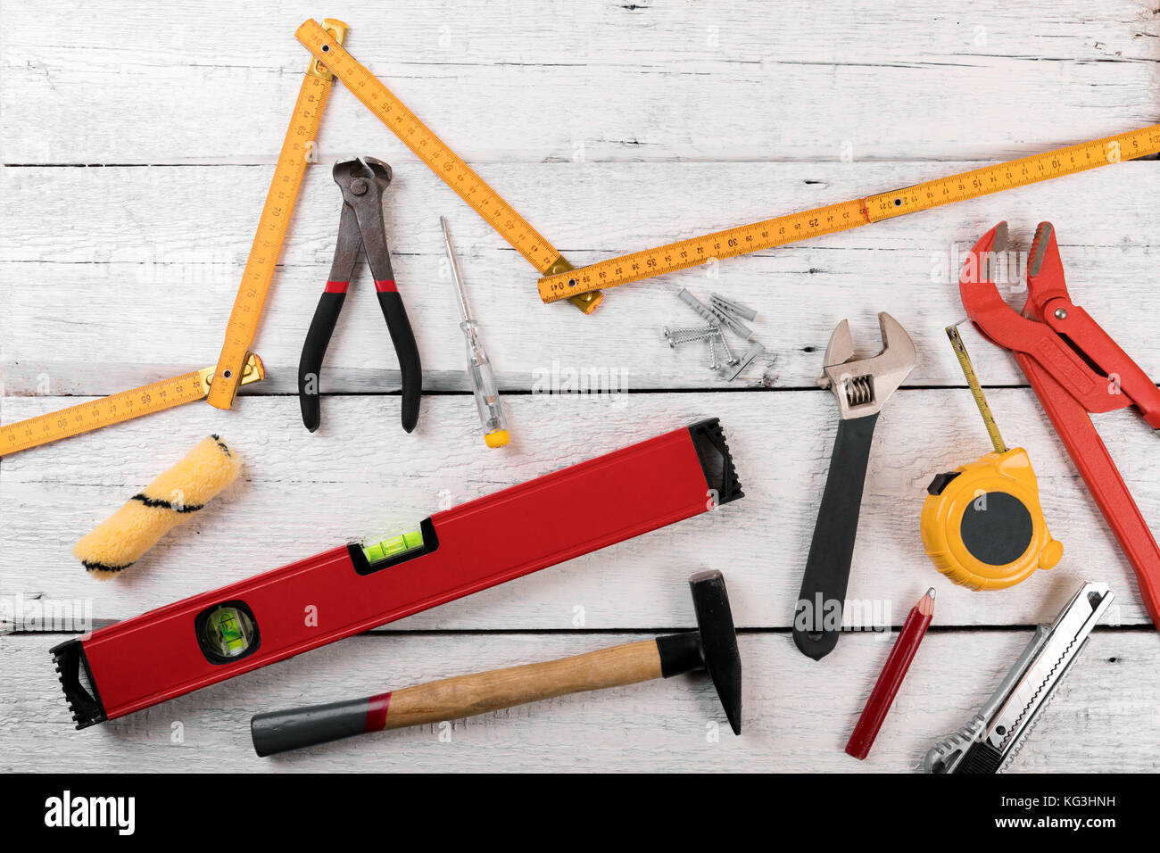 DIY construction tools for home improvement on white wooden background Stock Photo