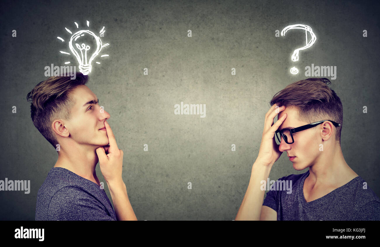 Two men thinking one has a question another solution with light bulb above head isolated on gray background. Stock Photo