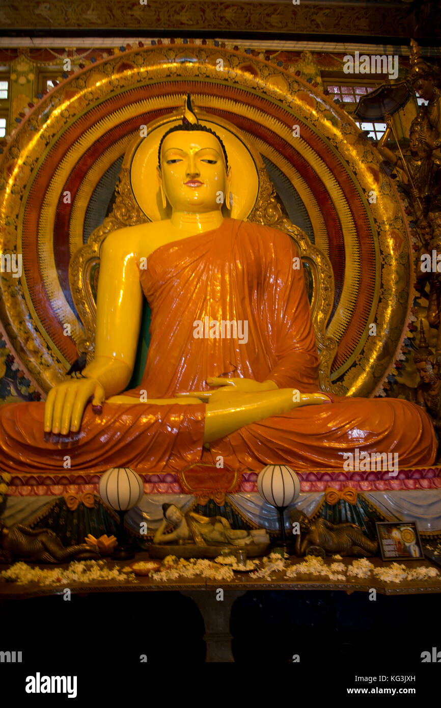 Colombo Sri Lanka Slave Island Gangaramaya Temple Image House Buddha Statue with the Bhumisparsha Mudra and seated in the Padmasana Position Stock Photo