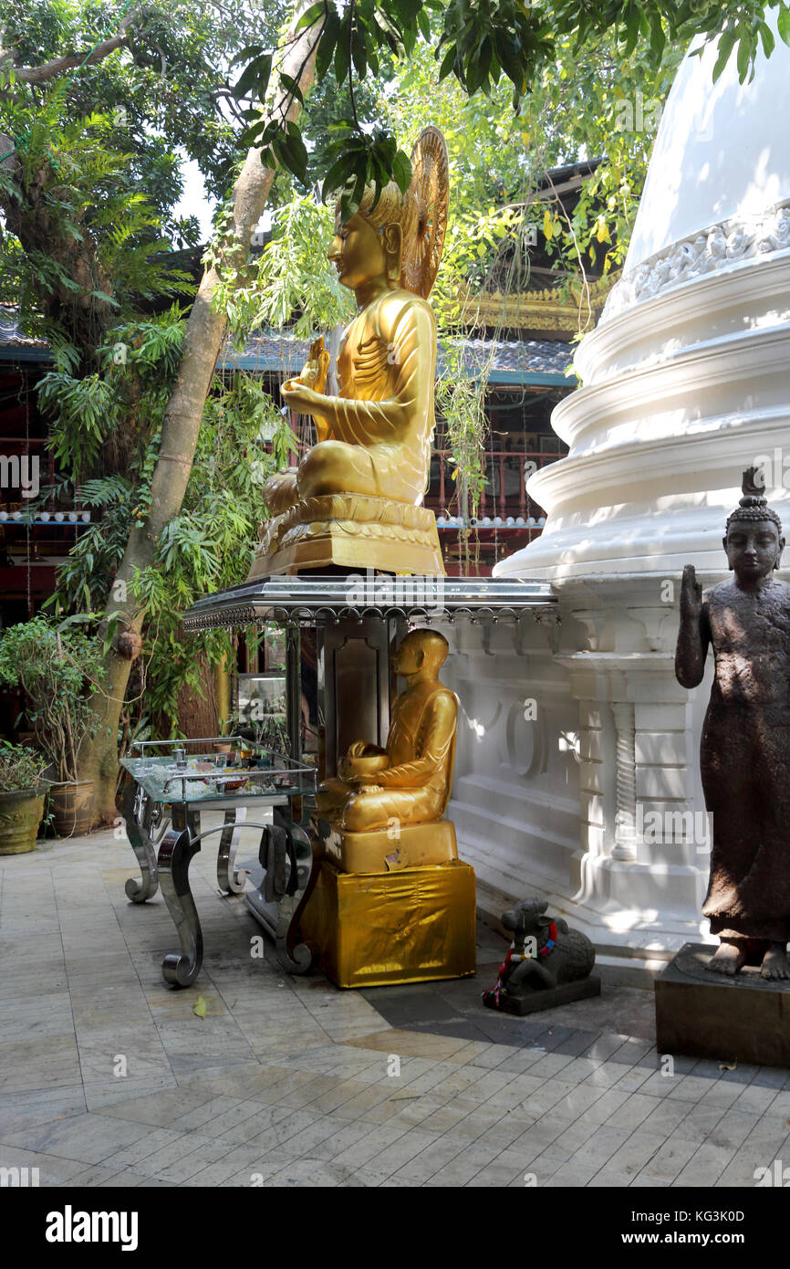 Colombo Sri Lanka Slave Island Gangaramaya Temple Gold Buddha Statues with Nandi outside of Dadoba Stock Photo