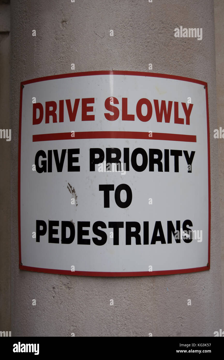 sign stating drive slowly and give priority to pedestrians, temple