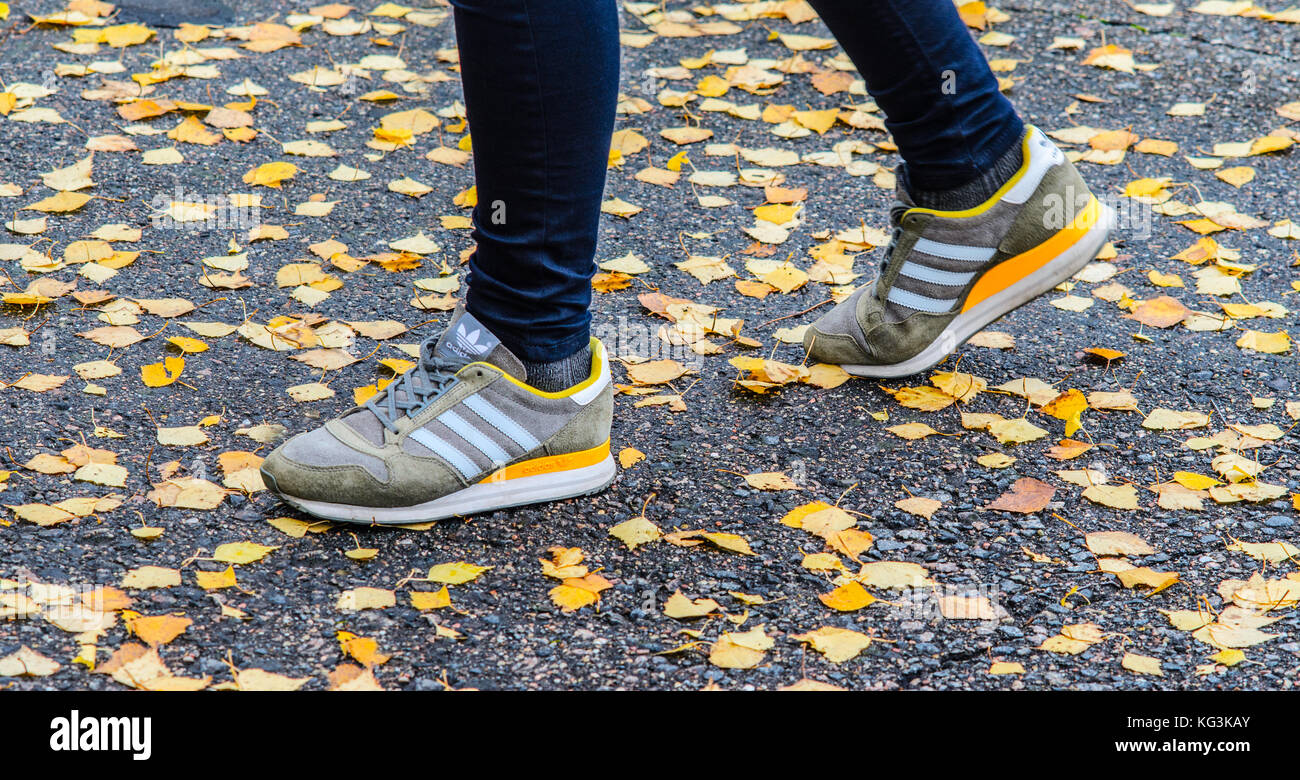Minsk, Belarus - October 14, 2017: Adidas shoes on legs on the wet asphalt  around fallen autumn leaves Stock Photo - Alamy