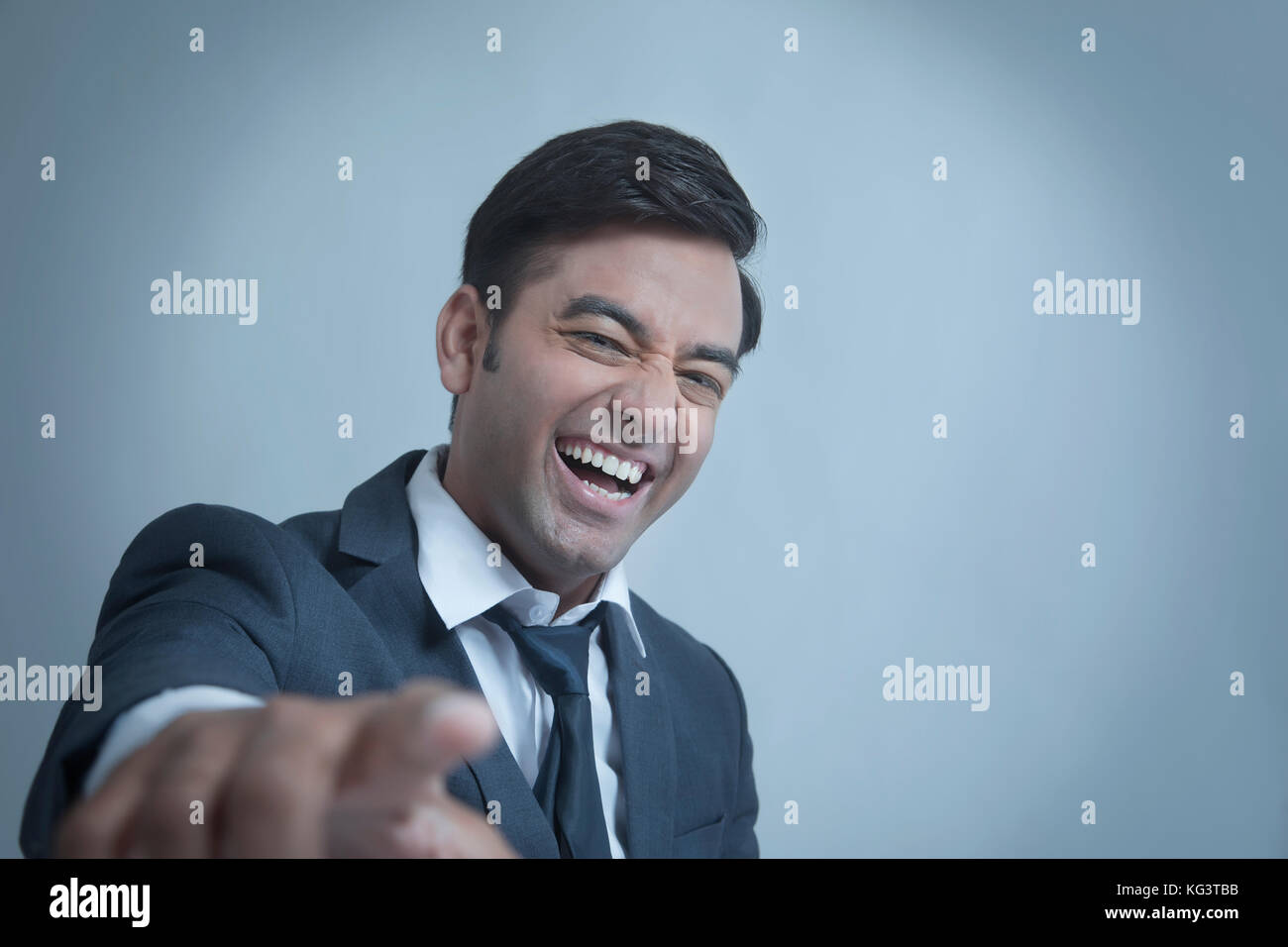 Young businessman smiling pointing at camera Stock Photo