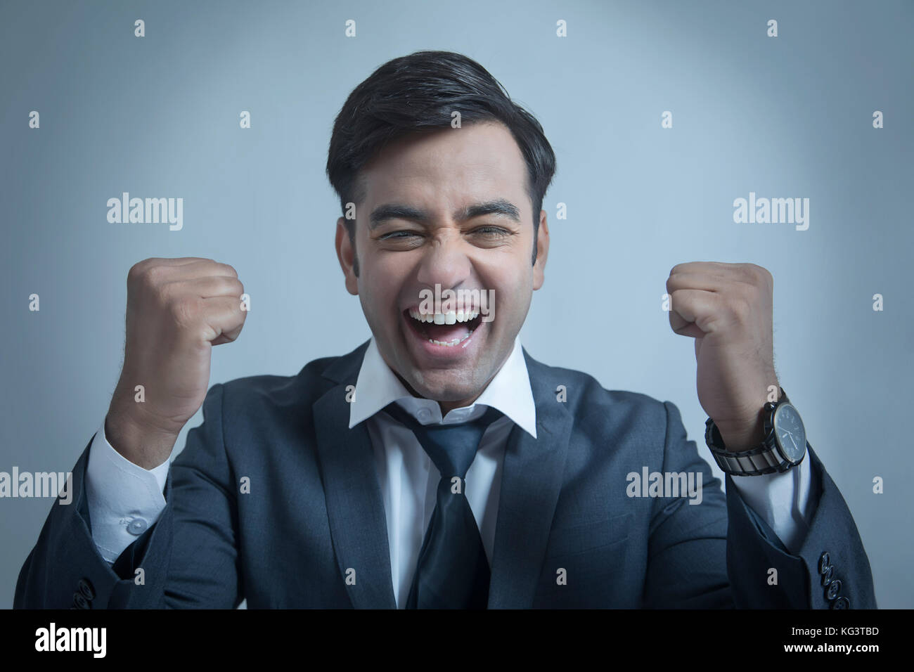Smiling businessman making fist Stock Photo