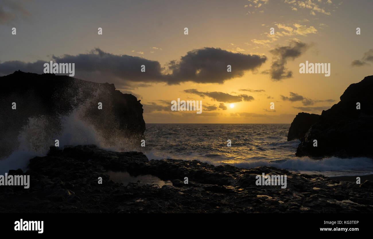 Splashing wave at sunrise in La Palma Island, Canary Archipelago. Stock Photo