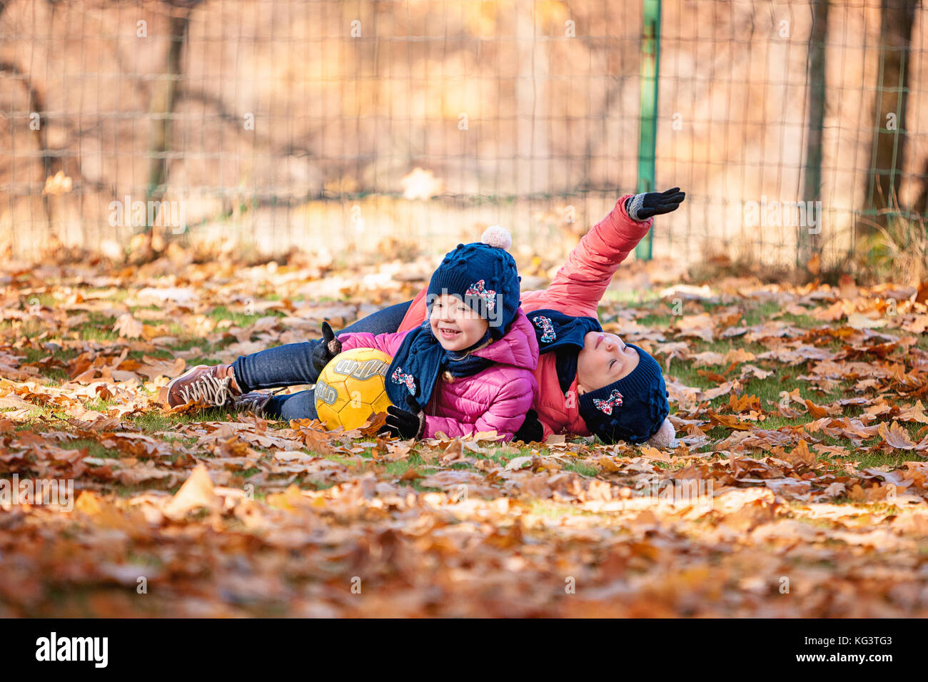 The two little baby girls playing in autumn leaves Stock Photo - Alamy