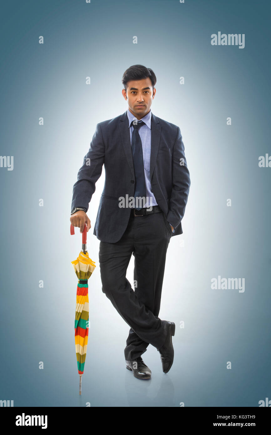 Portrait of businessman holding an umbrella Stock Photo