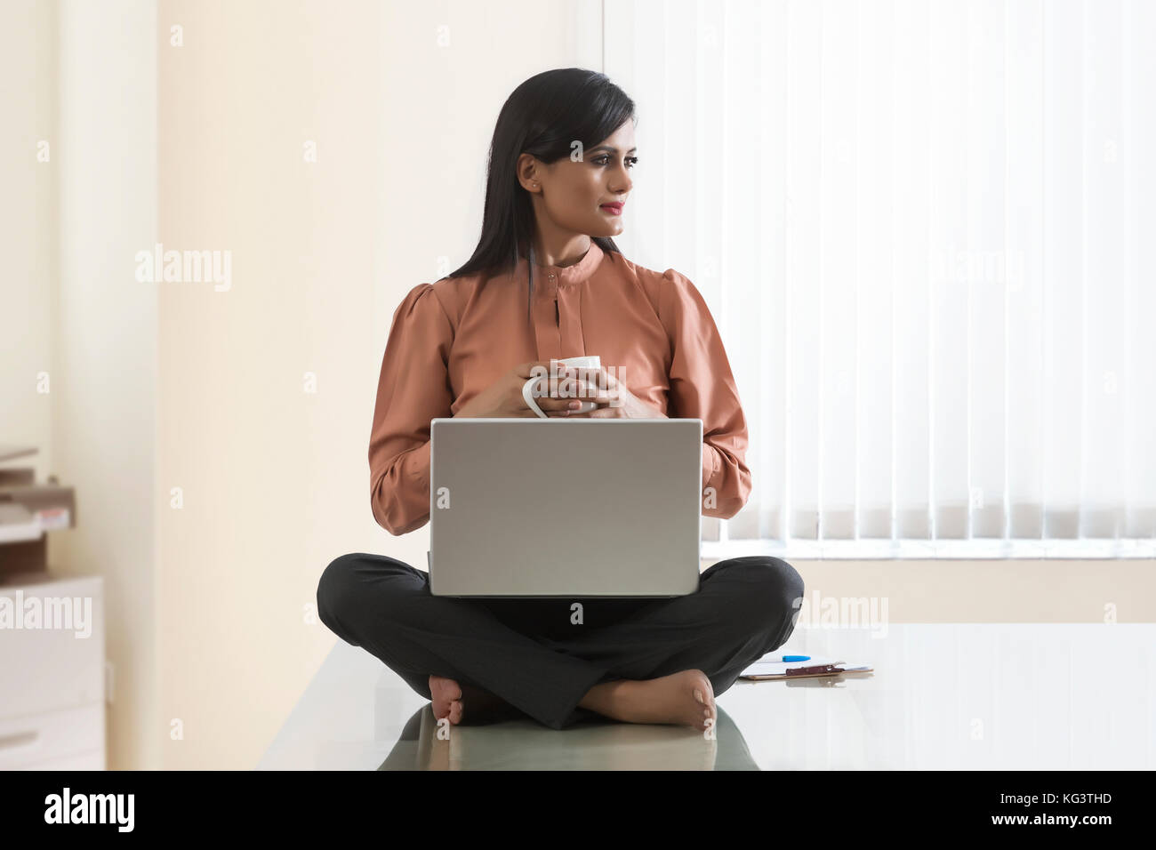 Indian woman sitting cross legged hires stock photography and images