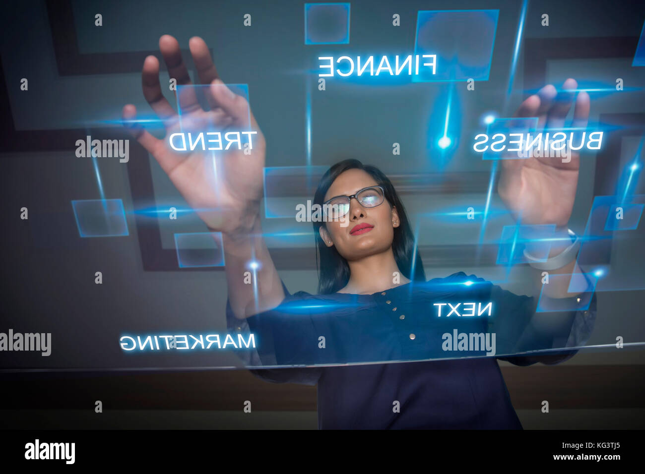 Businesswoman using futuristic computer keyboard Stock Photo