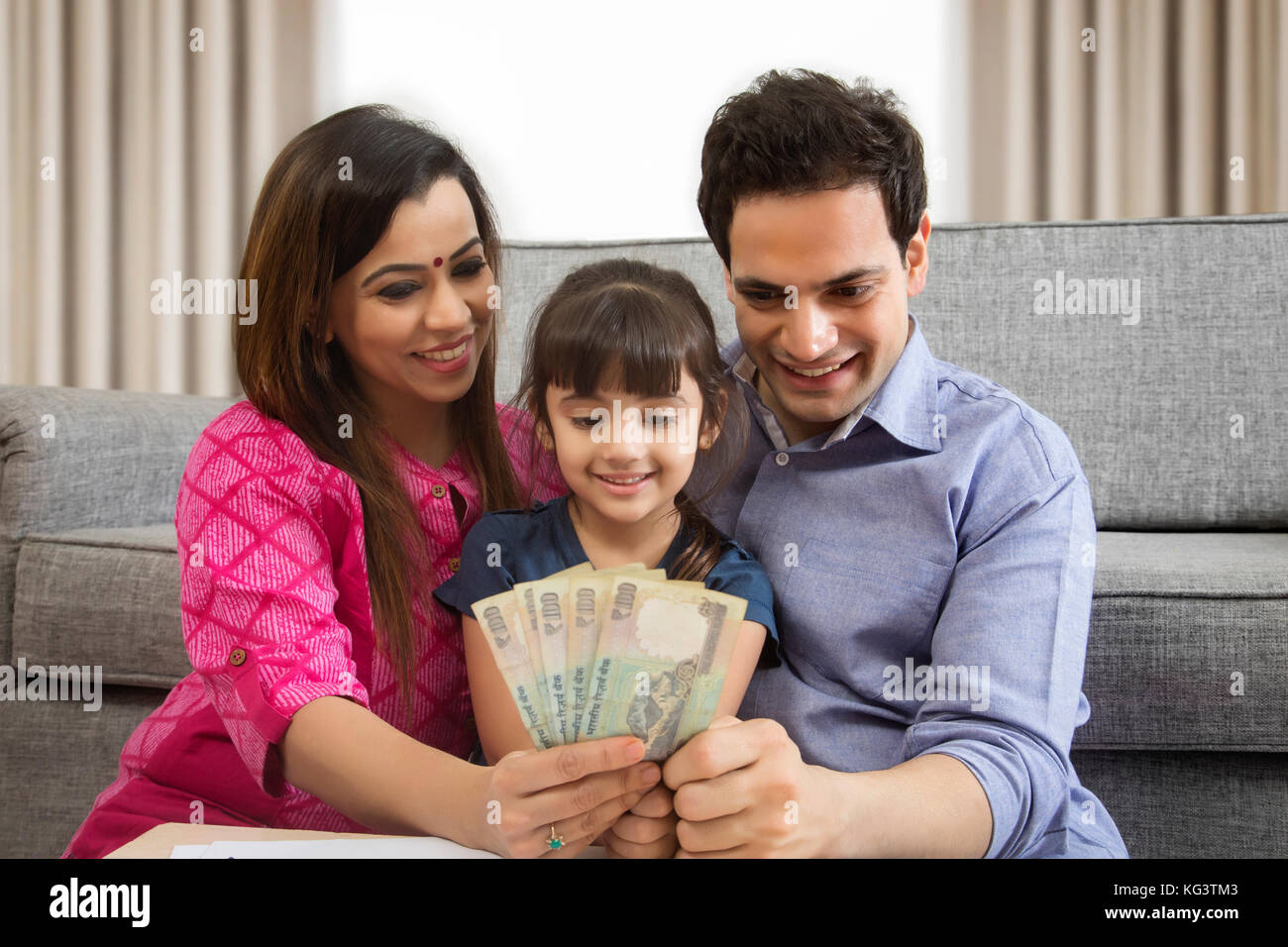 Family holding indian currency Stock Photo