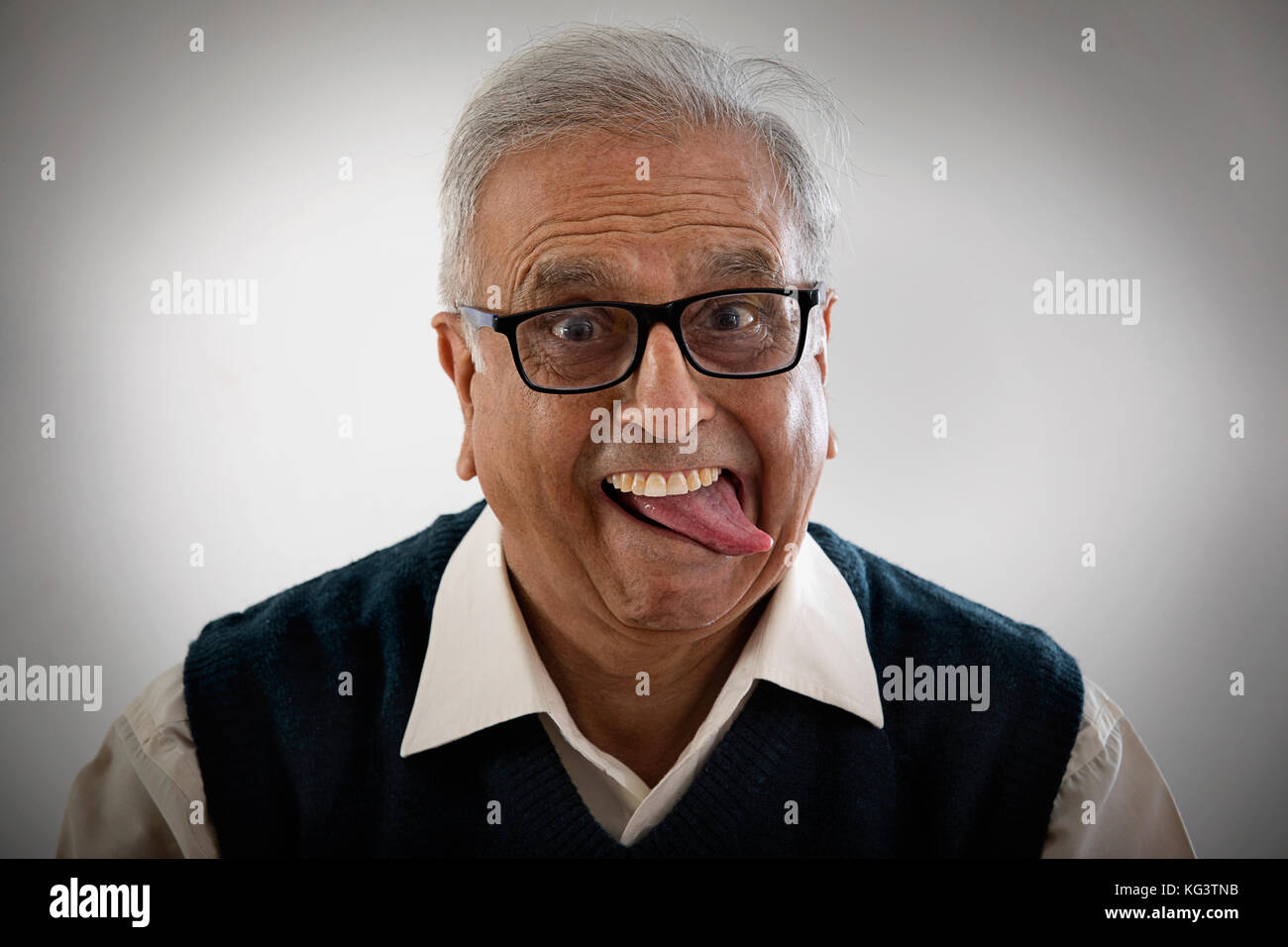 Portrait of an elderly man sticking his tongue out Stock Photo