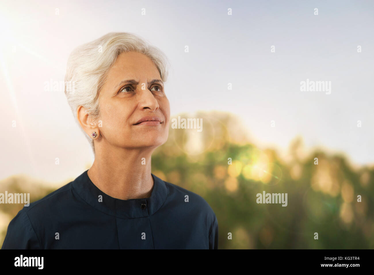 Senior woman looking away in nature Stock Photo