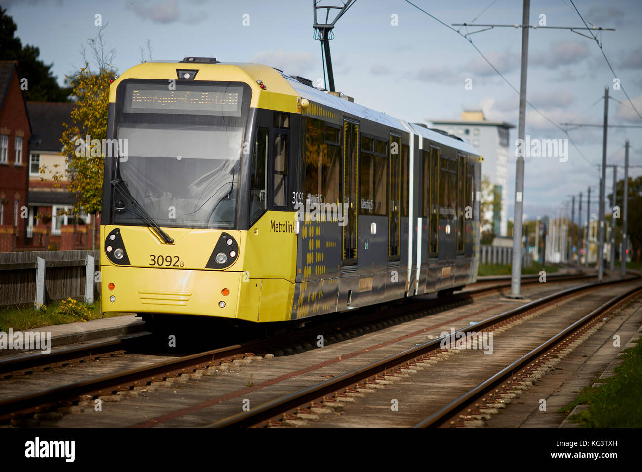 A yellow Metrolink Manchester tram at Brownlwy Road, Benchill, Wythenshawe. Stock Photo