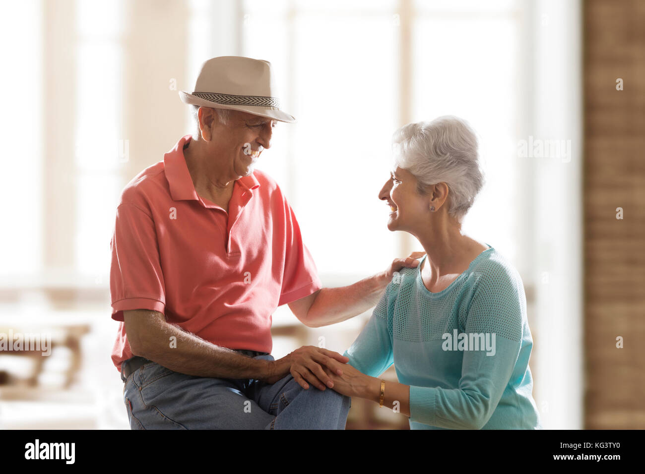 Happy senior couple sitting together and talking Stock Photo